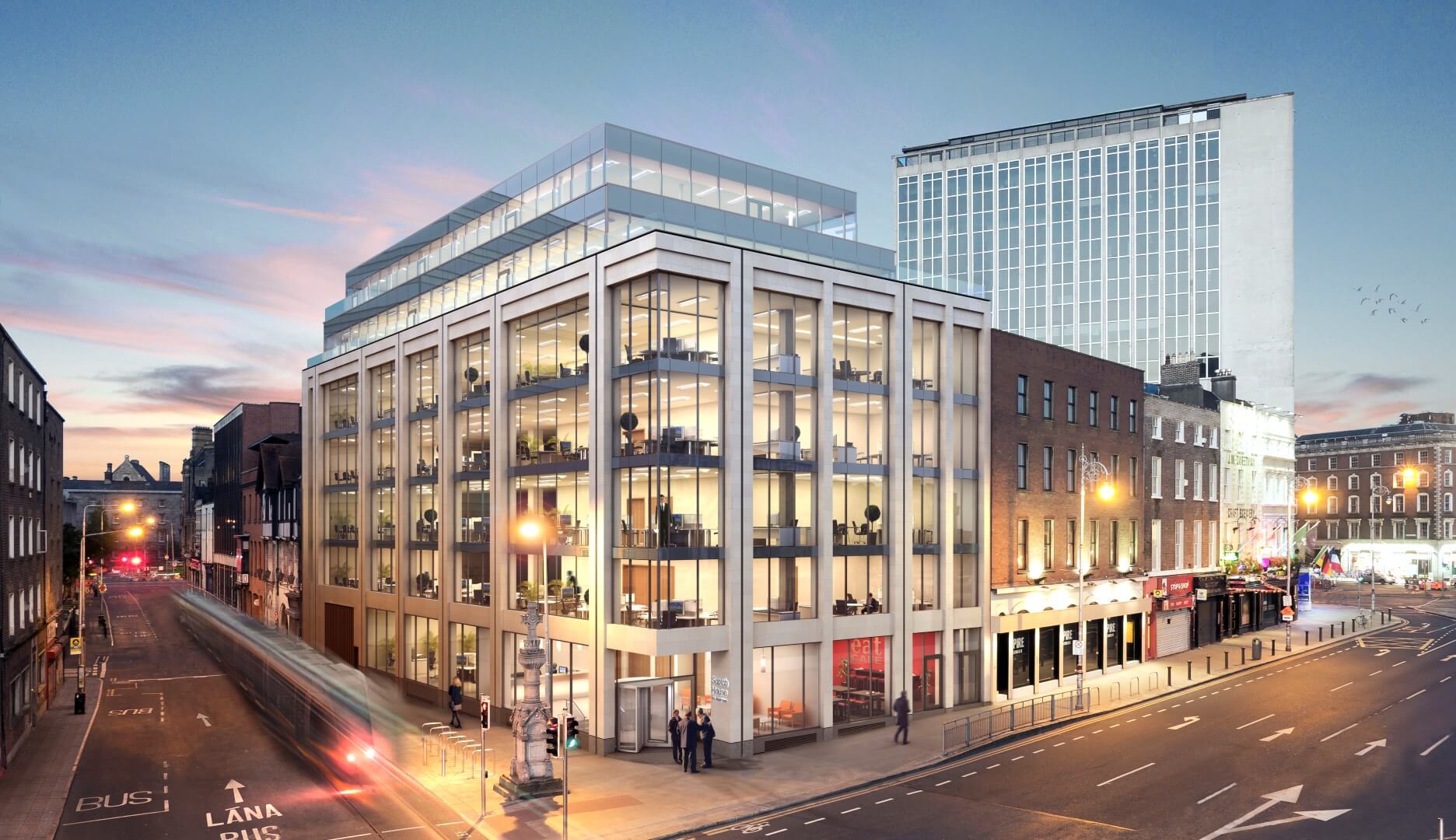 A modern office building designed by a renowned architect features large glass windows, standing prominently at a street corner during dusk. The streetlights illuminate the light traffic below, while the sunset sky paints a canvas of blue and pink hues.
