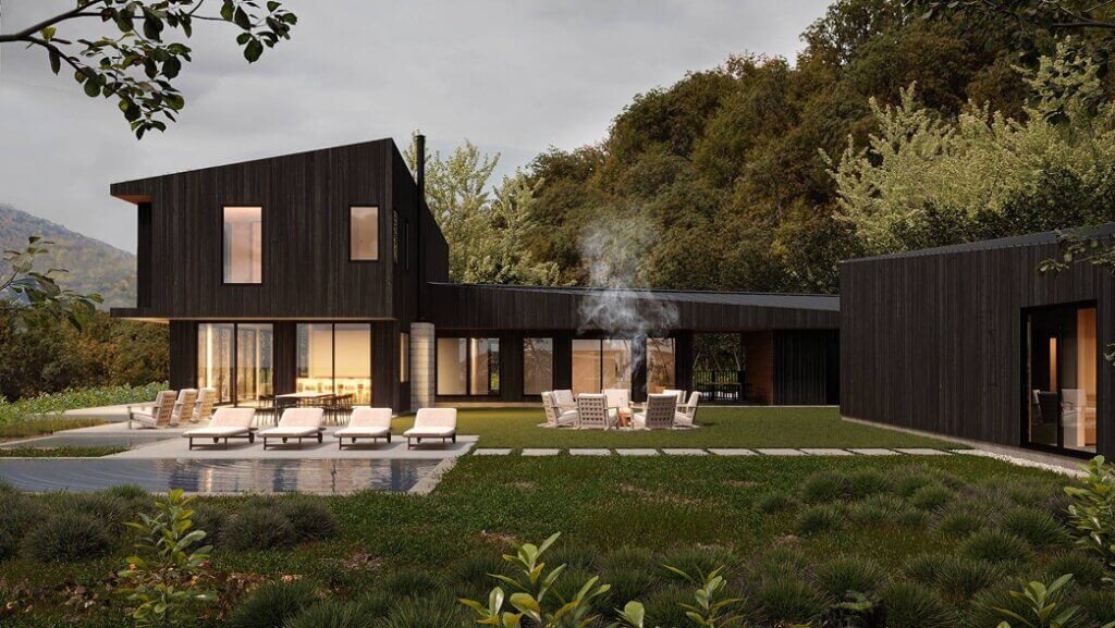 hudson valley modern mountain home rendering A modern dark-wood house with large windows is surrounded by greenery and trees. There are lounge chairs by a pool and people sitting around a fire pit on the lawn. Smoke rises from the fire into the evening sky.