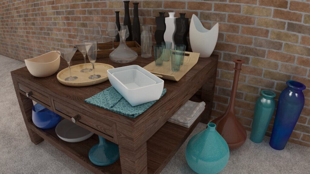 A wooden table against a brick wall holds assorted glassware, bowls, trays, and vases. Additional colorful vases are placed on the floor around the table. The tabletop and shelf display various decorative items.