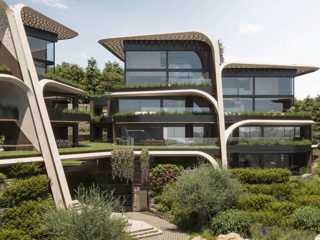 Modernes mehrstöckiges Gebäude mit grossen Glasfenstern, geschwungenen architektonischen Elementen und üppigem Grün auf den Balkonen und in der umgebenden Landschaft vor einer Kulisse aus Bäumen und blauem Himmel.