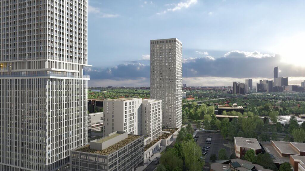 Eine Stadtlandschaft mit modernen Hochhäusern, umgeben von grünen Bäumen und einem Parkplatz, mit einer Mischung aus städtischen und natürlichen Elementen unter einem teilweise bewölkten Himmel.